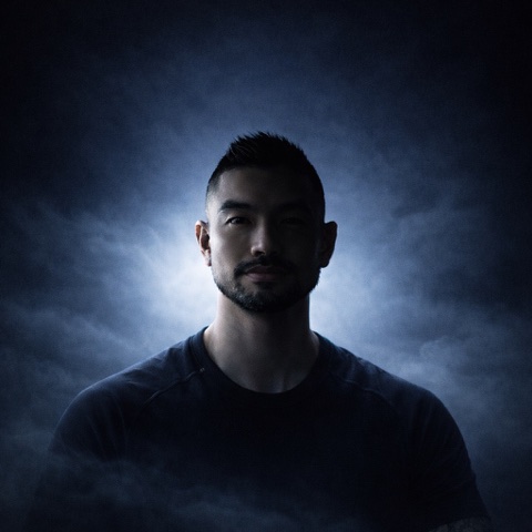 AWARENSS portrait against a dark cloud-filled background